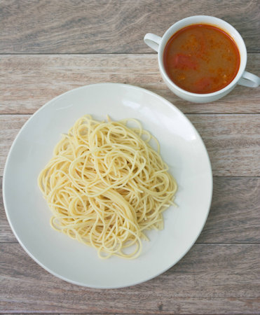 spaghetti with tomyum soup on wood backgroundの写真素材