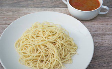 spaghetti with tomyum soup on wood backgroundの写真素材