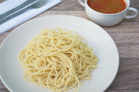 spaghetti with tomyum soup on wood backgroundの写真素材