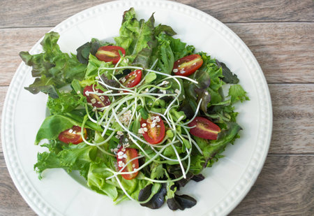 Fresh salad on wood backgroundの写真素材