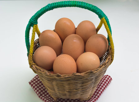 eggs in the basket on whire backgroundの写真素材