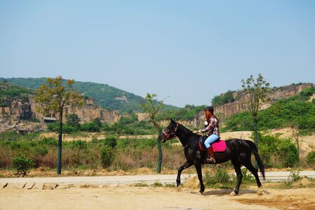 A woman riding on a horseのeditorial素材