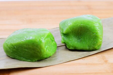 Qingming festival traditional cuisine - Two green dumplings on bamboo leafの写真素材