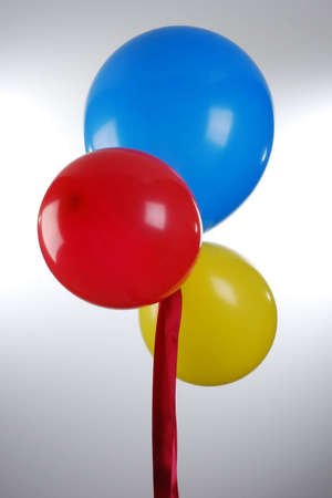 a bunch of colourful balloons floating in the airの写真素材