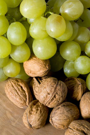 a composition of green grapes and nutsの写真素材