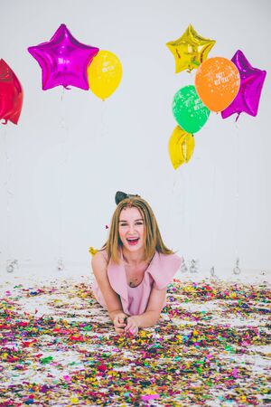 A young woman in the pink dress and a young man in the suit and jeans with merry Christmas, Happy New Year.の写真素材