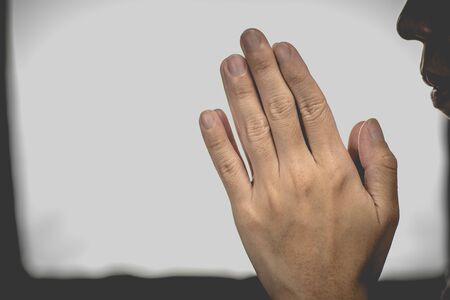 A woman is praying by her hands. Praying hands.