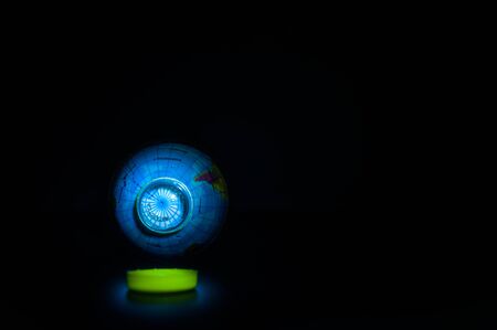 A globe in a plastic bottle on black background, which is concept of global environment from plastic.の写真素材
