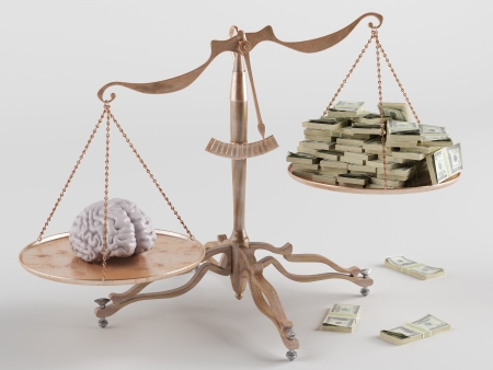 At one end of the scale the brain, on the other moneyの写真素材