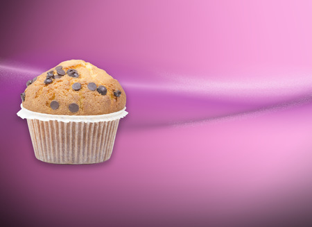 Pink wallpaper with a chocolate muffin and empty spaceの写真素材