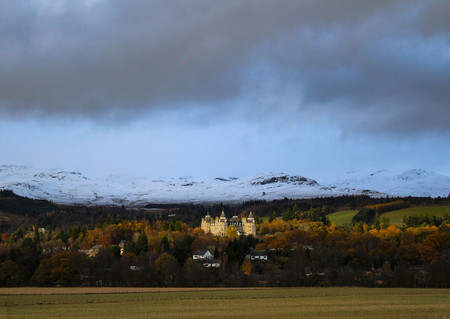 Magnificent stately home or castle illuminated by the sun after a storm in the early winter in the Scottish Highlands.の写真素材