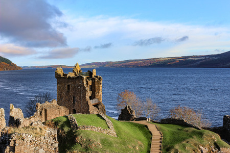 Beautiful sun drenched view of Urquhart Castle Ruins and Loch Ness in the Autumn or early winter.のeditorial素材