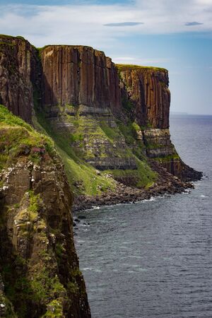 Gorgeous vibrant vertical view of Kilt Rock on the Trotternish peninsula of the Isle of Skye in Scotland.の写真素材