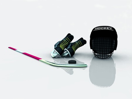 A collection of hockey gear (helmet, skates, stick and puck) lying on the ice.の写真素材