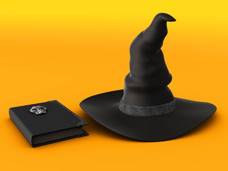 A witch hat and spell book on a halloween orange colored background.の写真素材