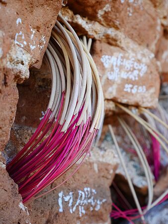 Bending incense sticks at Mingun Pagoda in Mandalay, Myanmar