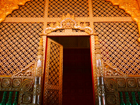 Ancient gold wooden door in Myanmarの写真素材