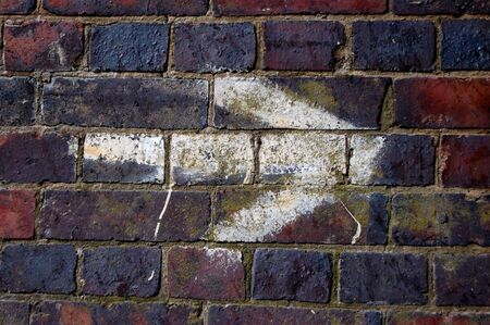 White arrow pointing right, painted on a brick wallの写真素材