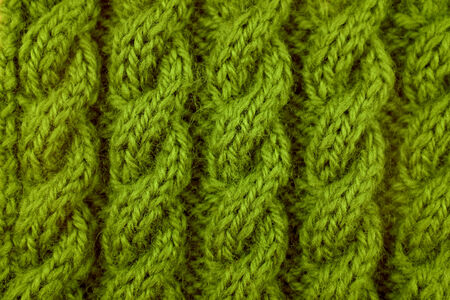 Closeup of green coiled rope cable knitting stitch