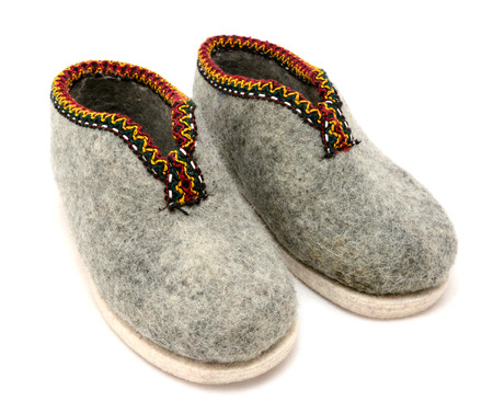 Pair of traditional Austrian embroidered felt slippers, isolated on white 