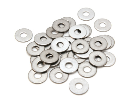 Pile of stainless steel flat washers, isolated on a white backgroundの写真素材