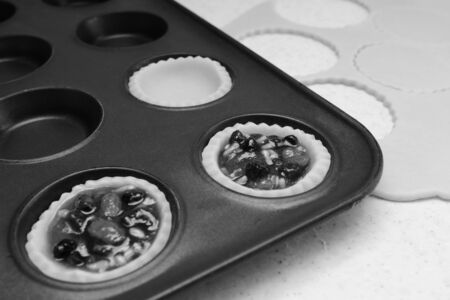 Making mince pies - pastry cases filled with traditional mincemeat - monochrome processingの写真素材