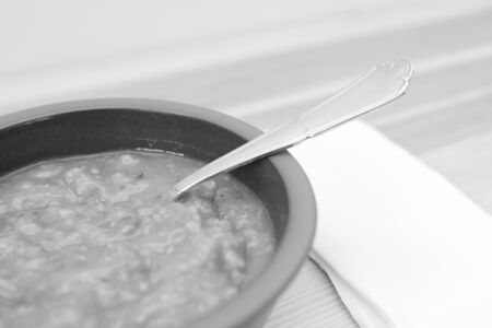Close-up of hearty vegetable and lentil soup on a wooden table - monochrome processingの写真素材