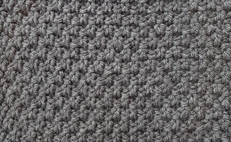 Seed stitch in grey yarn as an abstract background texture