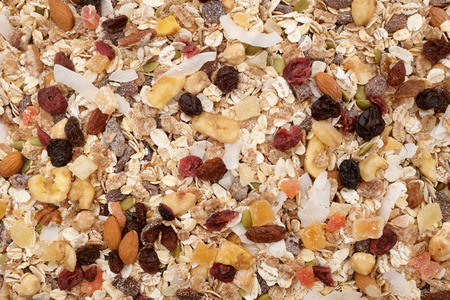 Muesli background - mixed fruit and nuts with cereal flakes and seeds as an abstract textureの写真素材