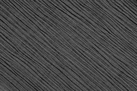 Crinkled fabric with irregular diagonal lines textile abstract background texture - monochrome...