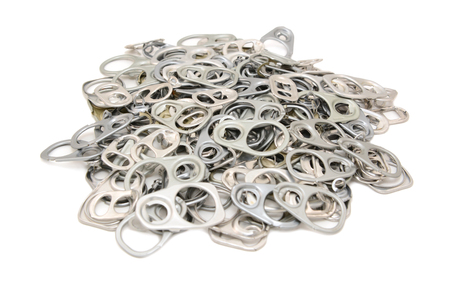Pile of discarded metal ring pulls from drink and food cans, on a white backgroundの写真素材