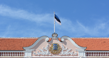 TALLINN, ESTONIA - May 12, 2018: Rooftop of Toompea Castle, the Estonian Parliament building in the Old Town of Tallinn. The Estonian flag flies above the parliament emblem.のeditorial素材