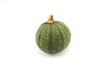 Small round ornamental gourd with green skin for decoration, on a white backgroundの写真素材