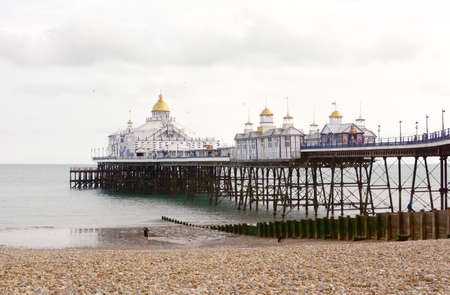 EASTBOURNE, UK - AUGUST 28, 2019: 300m long pleasure pier with gold-topped towers, built out into the sea in Eastbourne, UK on August 28, 2019のeditorial素材