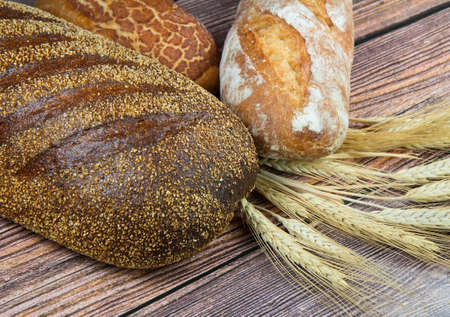 Close-up of different types of bread on wooden の写真素材