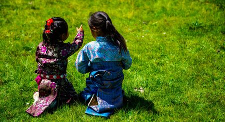 Little sister sit on the grasslandのeditorial素材