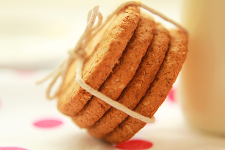 Healthy home made oatmeal biscuits and a bottle of fresh milkの写真素材