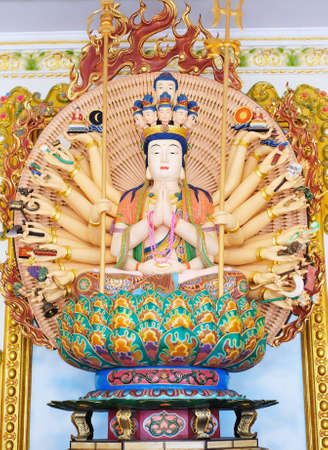Quan Yin - Buddhist Goddess of mercy - statue isolated on goldの写真素材