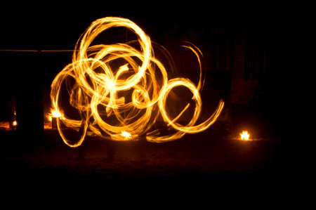 Fire and fire sparkles traces of fire dancing on the beach taken using long exposure technique.