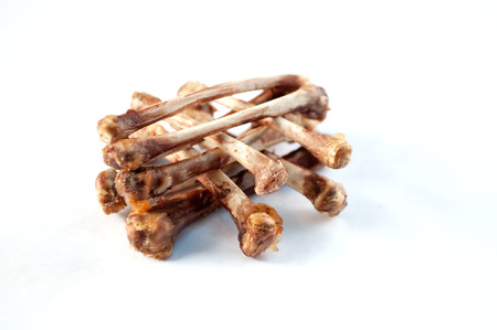 Pile of chicken bones on white backgroundの写真素材