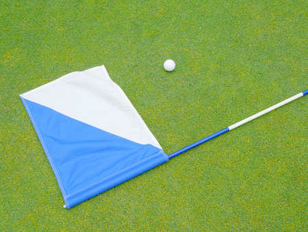 flag and golf ball on the greenの写真素材