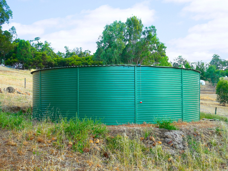 Big green water tank in rural areaの写真素材