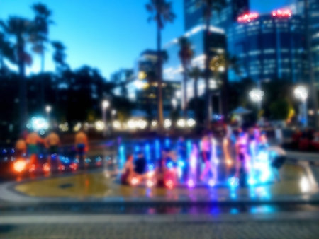 Children playing among the water fountain at water park. Blurred background.の写真素材