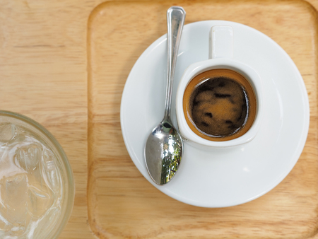 Espresso in a cup on wooden tray. Top view.の写真素材