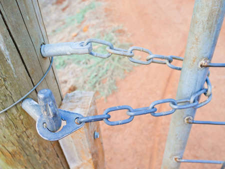 Gate held with chain in rural areaの写真素材