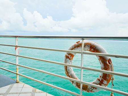 Life buoy hanging on railingの写真素材