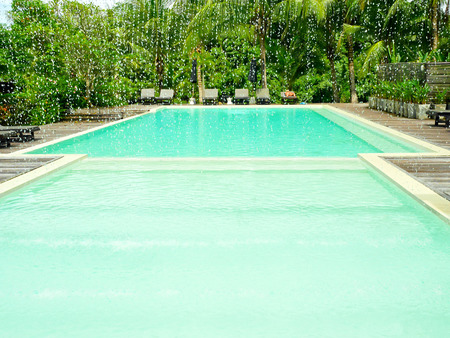 sun loungers by the pool in luxury resortの写真素材