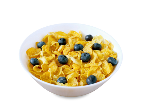 Golden cornflakes cereal with blueberries isolated on white background