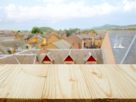Wooden table for product display and view of houses in Inverness, Scotlandの写真素材