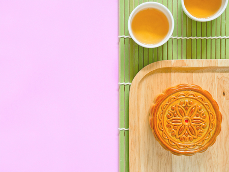 Mooncake on a wooden plate for Mid-Autumn Festival or Mooncake Festival with copy spaceの写真素材